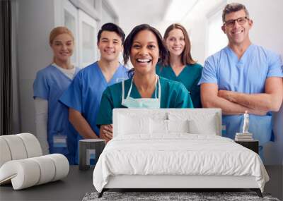 portrait of laughing multi-cultural medical team standing in hospital corridor Wall mural