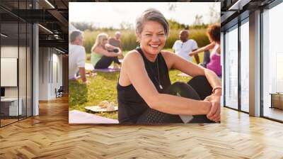 Portrait Of Mature Woman On Outdoor Yoga Retreat With Friends And Campsite In Background Wall mural