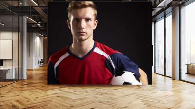 Portrait Of Professional Soccer Player With Ball In Studio Wall mural