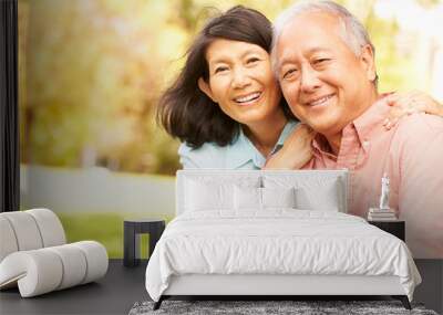 Portrait Of Senior Asian Couple Sitting In Park Together Wall mural