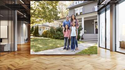 Portrait Of Smiling Family Standing In Front Of Their Home Wall mural