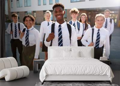 Portrait Of Smiling Male And Female High School Students Wearing Uniform Outside College Building Wall mural