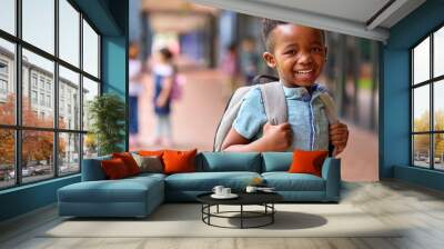 Portrait Of Smiling Male Elementary School Pupil Outdoors With Backpack At School Wall mural