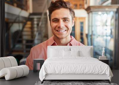 Portrait Of Smiling Male Owner Of Fashion Store Standing In Front Of Clothing Display Wall mural