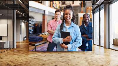 Portrait Of Smiling Multi-Cultural Sales Team In Fashion Store In Front Of Clothing Display Wall mural