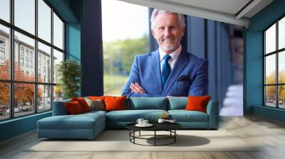 Portrait Of Smiling Senior Businessman CEO Chairman Standing Inside Modern Office Building Wall mural