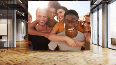 Portrait Of Smiling Young Friends Walking Outdoors Together Wall mural