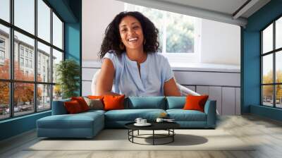 Portrait Of Woman Sitting In Chair At Home Wall mural