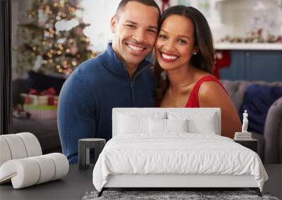 Romantic Couple Exchanging Christmas Gifts At Home Wall mural