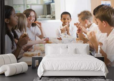 Schoolchildren enjoying their lunch in a school cafeteria Wall mural