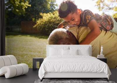 Senior black man with grandson riding on his back Wall mural