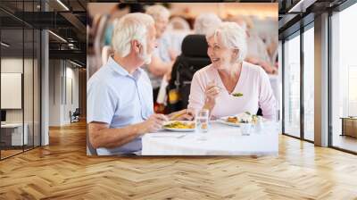 Senior Couple Eating Meal And Talking In Retirement Home Wall mural