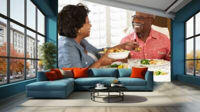 senior couple enjoying meal at home Wall mural