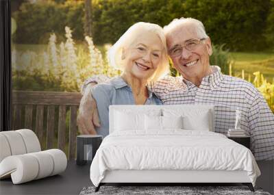 Senior Couple Sitting On Garden Bench In Evening Sunlight Wall mural