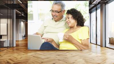 senior couple using laptop at home Wall mural