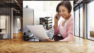 Senior Hispanic woman working on computer at home Wall mural