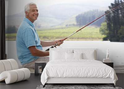 Senior man fishing on jetty Wall mural