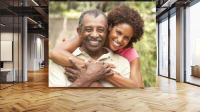 senior man hugging adult daughter Wall mural