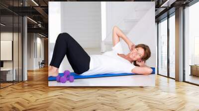 senior woman doing curl-ups Wall mural