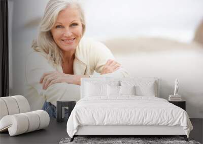 Senior Woman On Holiday Sitting On Winter Beach Wall mural