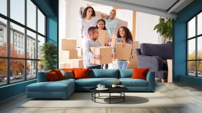 Smiling Family Carrying Boxes Into New Home On Moving Day Wall mural