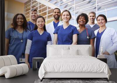 Smiling medical team standing together outside a hospital Wall mural