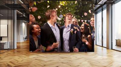 Smiling people celebrating wedding party in backyard Wall mural