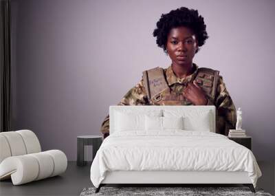 Studio Portrait Of Serious Young Female Soldier In Military Uniform Against Plain Background Wall mural