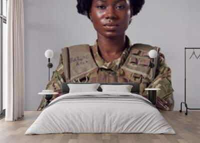 Studio Portrait Of Serious Young Female Soldier In Military Uniform Against Plain Background Wall mural