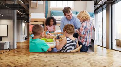 Teacher And Pupils Working At Tables In Montessori School Wall mural