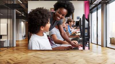 Teacher Helping Male Pupil Line Of High School Students Working at Screens In Computer Class Wall mural