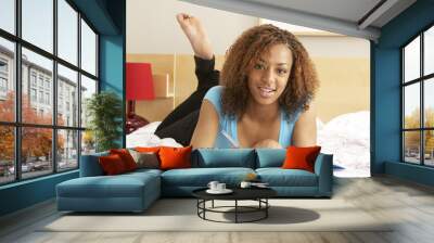 Teenage Girl Writing In Diary In Bedroom Wall mural