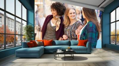 Three Female Friends Shopping In Mall Together Wall mural