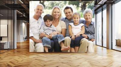 Three Generation Family Sitting On Sofa At Home Wall mural