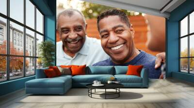 Three generations of family men laughing together, close up Wall mural