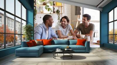 Three Male Friends Meeting For Lunch In Coffee Shop Wall mural