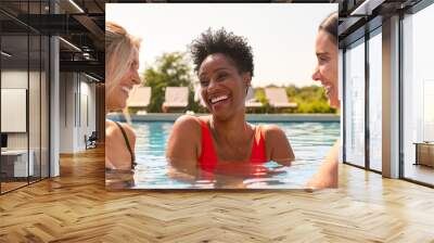 Three Mature Female Friends Wearing Swimsuits In Outdoor Pool On Spa Day Wall mural