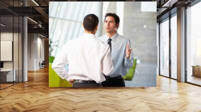 two businessmen having informal meeting in modern office Wall mural