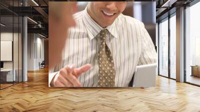 two businessmen in boardroom with laptop talking Wall mural