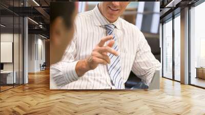 Two businessmen in boardroom with laptop talking Wall mural