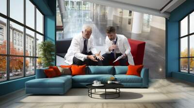 two doctors having meeting in hospital reception area Wall mural