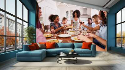 Two Families Enjoying Eating Meal At Home Together Wall mural