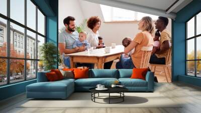 Two Families With Babies Meeting And Talking Around Table On Play Date At Home Wall mural