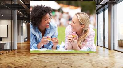 Two Female Friends Enjoying Cupcakes At Outdoor Summer Event Wall mural