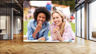 Two Female Friends Enjoying Cupcakes At Outdoor Summer Event Wall mural