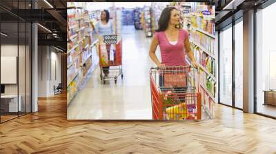 two women shopping in supermarket Wall mural