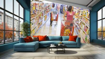 Two women shopping in supermarket Wall mural