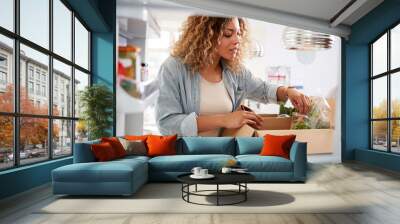 View Looking Out From Inside Of Refrigerator As Woman Unpacks Online Home Food Delivery Wall mural