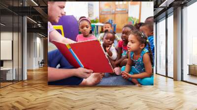 Volunteer teacher reading to a class of preschool kids Wall mural