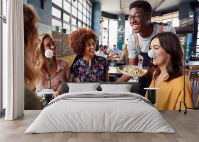 Waiter Serving Group Of Female Friends Meeting For Drinks And Food In Restaurant Wall mural